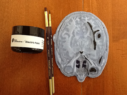 Top surface of 3D printed head section with electric paint covering regions for which information is to be delivered when touched
